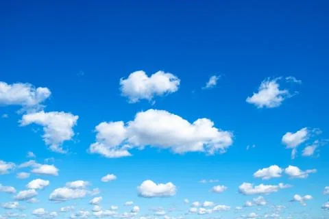 Many little fluffy clouds in blue sky in sunny day Stock Photos