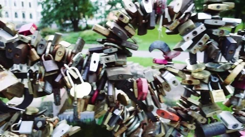 Many locks are attached to metal fence in park Stock Footage 80142089
