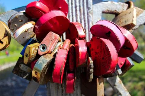Many locks, different colors fastened in one place. Stock Photos