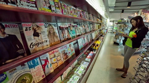Many Magazines on Wall Shelf Convenience Store Lady Reading Browsing 動画素材 46014221