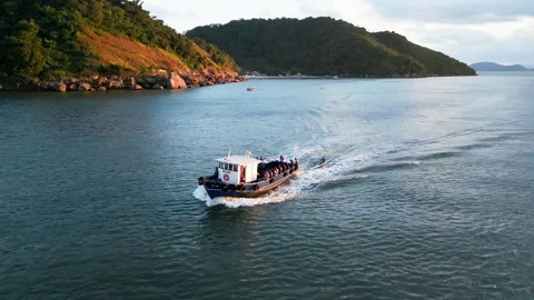 Many Men returning from work in a boat. Playing sports rowing behind a boat. Stock Footage 246819368