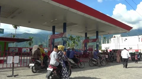 Many motorcyclists stop in front of gas stations Stock Footage 199032998