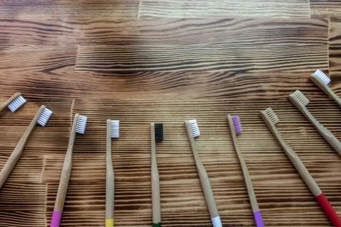 Many multi-colored bamboo toothbrushes. eco friendly.  place for text. Stock Photos