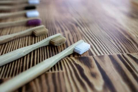 Many multi-colored bamboo toothbrushes. eco friendly. close-up of bristles Stock Photos