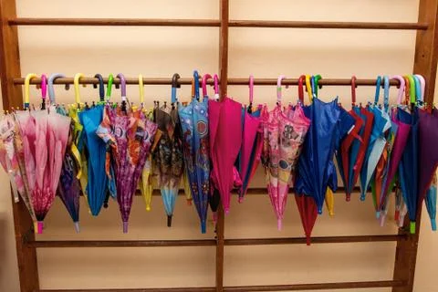 Many multi-colored children's umbrellas Stock Photos