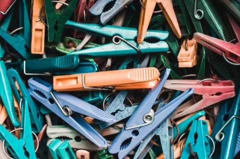 Many multi-colored clothespins close-up as a background. Stock Photos