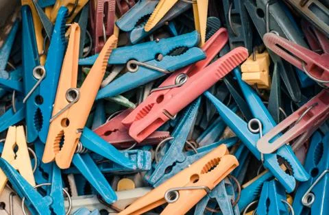 Many multi-colored clothespins close-up as a background. Stock Photos