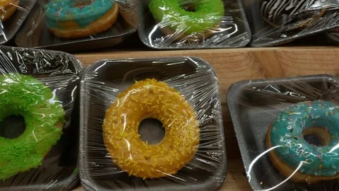 Many multi-colored donuts desserts with various sprinkles and chocolate, confect Stock Footage 280413629