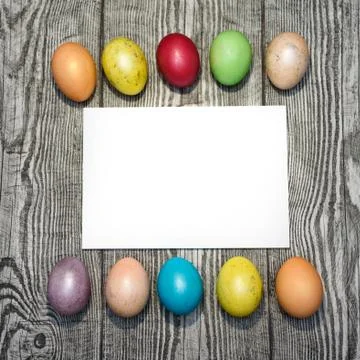 Many multi colored easter eggs on the wooden background. Stock Photos