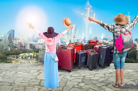 Many multi-colored large suitcases on wheels on the seashore. Concept of travel Stock Photos
