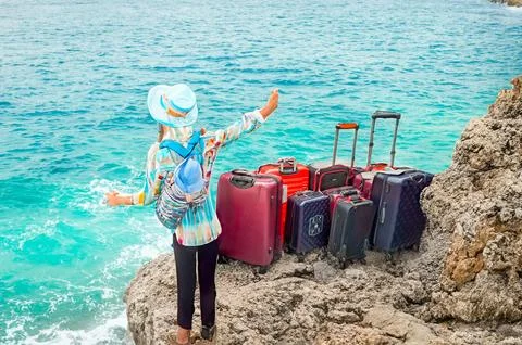 Many multi-colored large suitcases on wheels on the seashore. Concept of travel Stock Photos