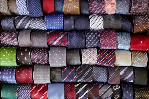 Many multi-colored with patterns of ties lying in a row Stock Photos