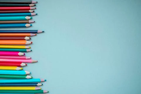 Many multi-colored pencils on isolated on a blue background Stock Photos