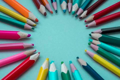 Many multi-colored pencils on isolated on a blue background Stock Photos