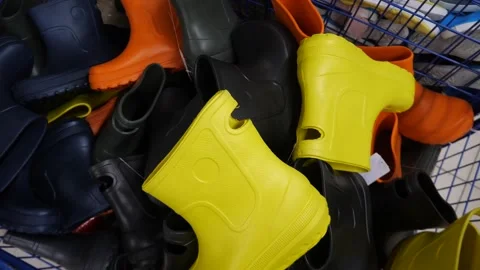 Many multi-colored rubber boots lying in a box. 스톡 동영상 312169394