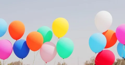 Many multicolored balloons at wind on sky background Stock Footage 94728025