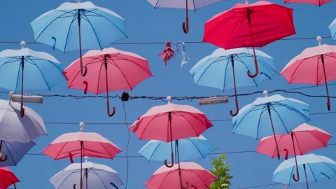 Many multicolored open umbrellas hanging from above Stock Footage 247848032