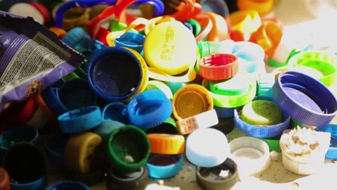 Many multicolored plastic bottle caps, recycling purposes, small factory Ukraine Stock-Footage 202125126