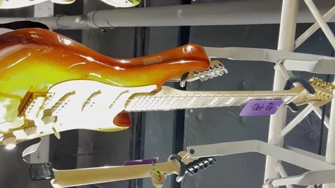 Many new electric guitars in the interior of a music store. Stringed musical Video stock 250028626