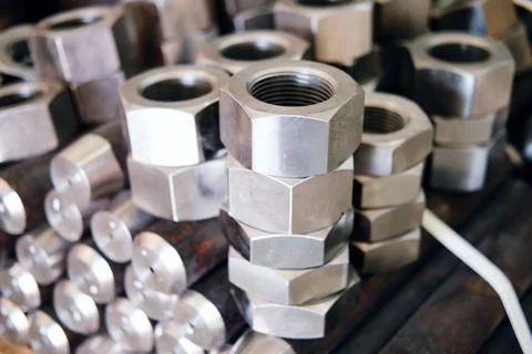Many new nuts of different sizes lie stacked on top of each other Stock Photos