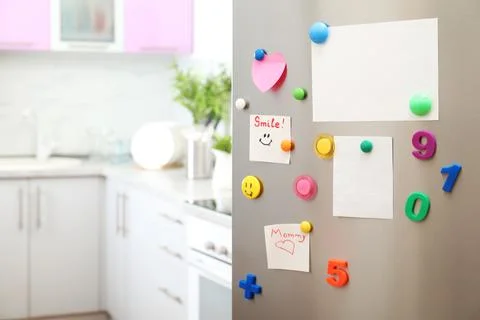Many notes and empty sheets with magnets on refrigerator door in kitchen. Spa Stock Photos