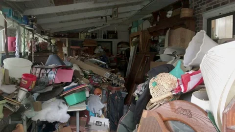 Many objects, furniture and stuff hoarded and piled in room of building, Vídeos de archivo 134179079