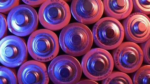 Many old alkaline batteries, backlit with red and blue light. Pattern. Stock Footage 162372671