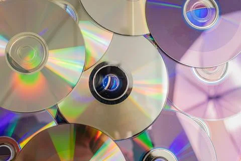 Many old CDs represent technology from the 90s. Stacks of CDs, old songs an.. Stock Photos