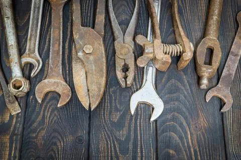 Many old tools stacked after work on black vintage wooden boards Stock Photos