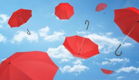 Many open red umbrellas falling from the blue sky dotted with clouds Stock Photos