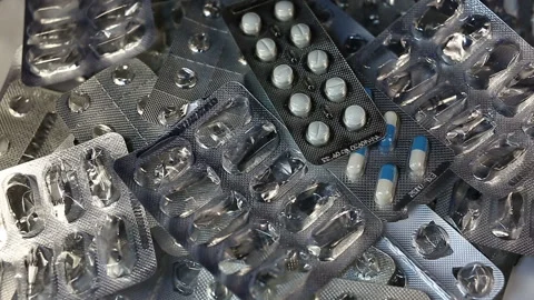 Many packages of empty and not started pills fall into a pile. Real time, medium Stock Footage 145586667