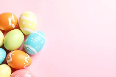 Many painted Easter eggs on color background, top view. Space for text Stock Photos