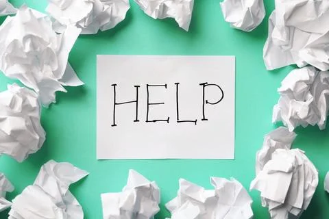Many paper balls and note with word HELP on color background, top view Stock Photos