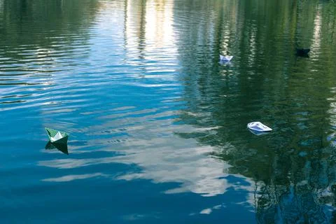 Many paper skiffs float on the water Stock Photos
