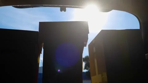 Many parcels in trunk hatchback car while young courier driver in cap unloading Video stock 249769427