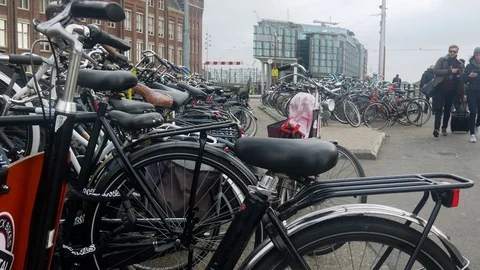 Many parked bicycles in the central area of Amsterdam at a busy autumn day Stock Footage 102734245