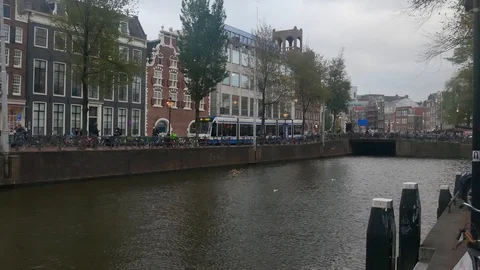 Many parked bicycles in the central area of Amsterdam at a busy autumn day Stock Footage 102798273