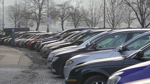 Many Parked cars on a street in Prague in cloudy wintry day Stock Footage