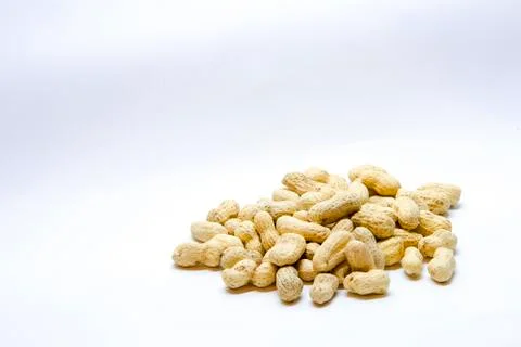 Many peanuts in the shell on a white background Stock Photos