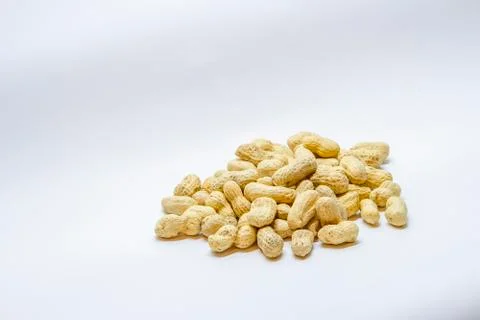 Many peanuts in the shell on a white background Stock Photos
