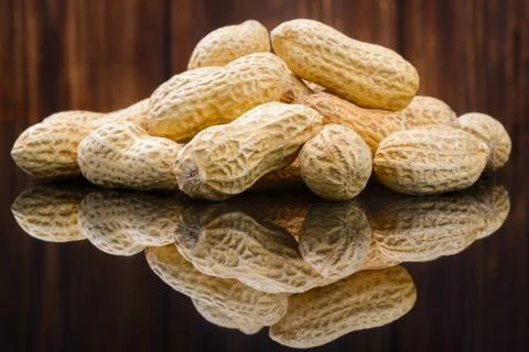 Many peanuts in shells, one upon the other Stock Photos