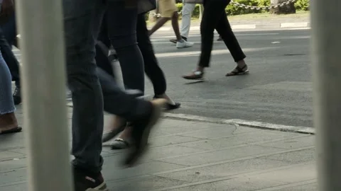 Many pedestrians' legs crossing an intersection on city pavement at a Video stock 149088659