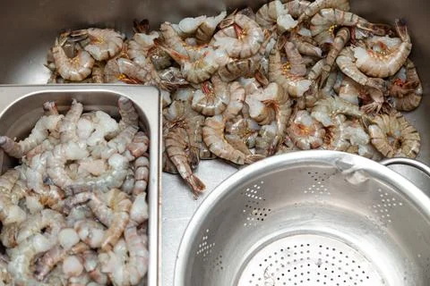 Many peeled raw headless large shrimps without shell Stock Photos