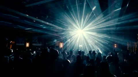 Many people are dancing on a dance floor in the light of projectors. Stock Footage 227319032