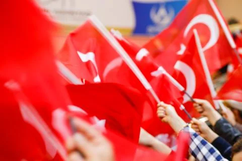 Many people are waving Turkish flags in their hands. Stock Photos