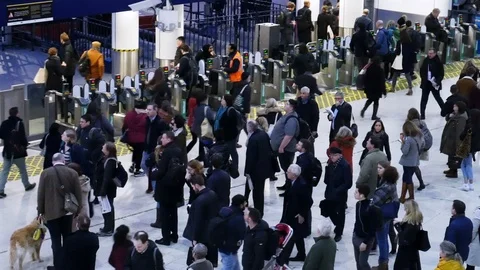Many people in front of ticket barriers at rush hour in Waterloo train, London Stock Footage 102948026