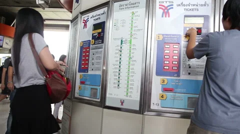 Many people go to buy tickets from ticket machines at sky train station Stock Footage