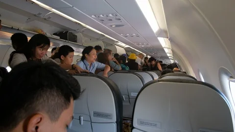 Many people on passageway inside the plane and looking for a seat in the planes Stock Footage 103031175