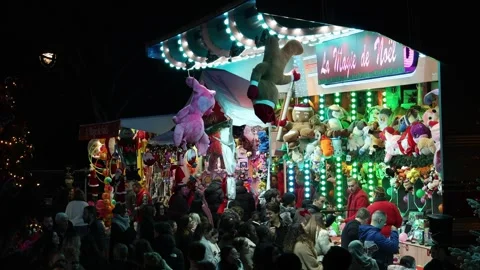 Many people playing games at the plush animal carnival game stall. Stock Footage 327502622