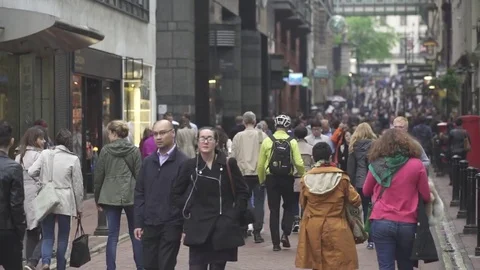 Many people strolling down a main street Stock Footage 82314266